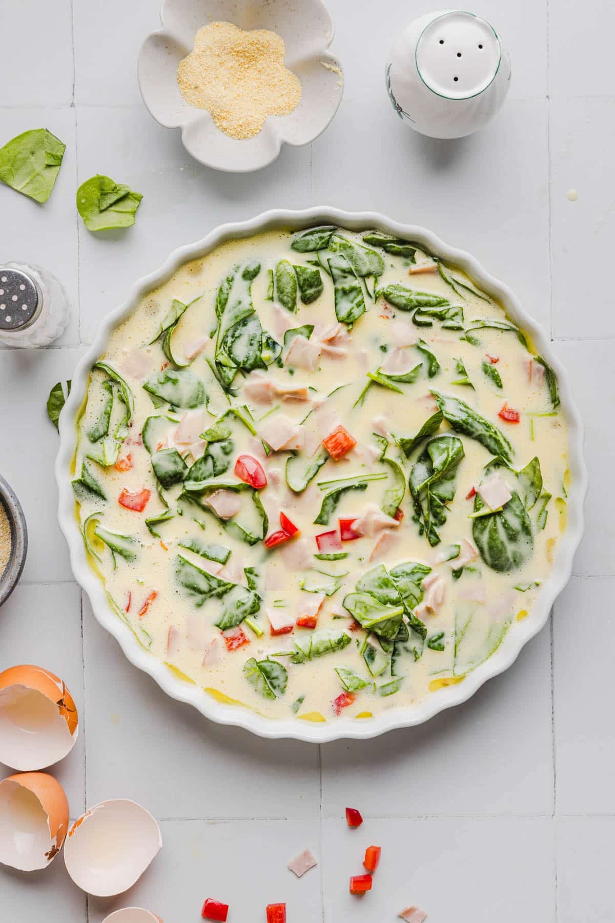 The quiche mixture in a round 9-inch dish before baking.