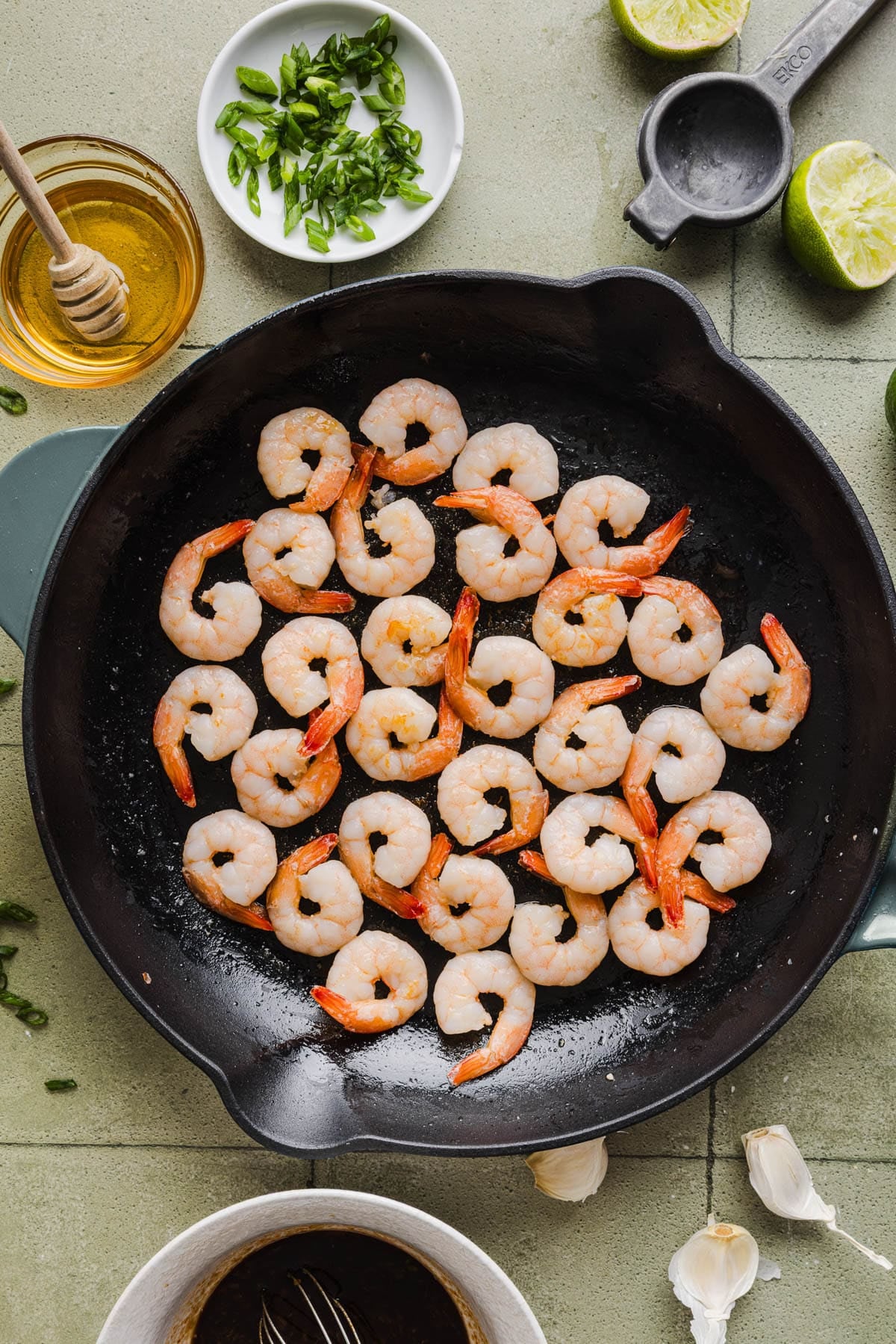 The cooked shrimp in the skillet.