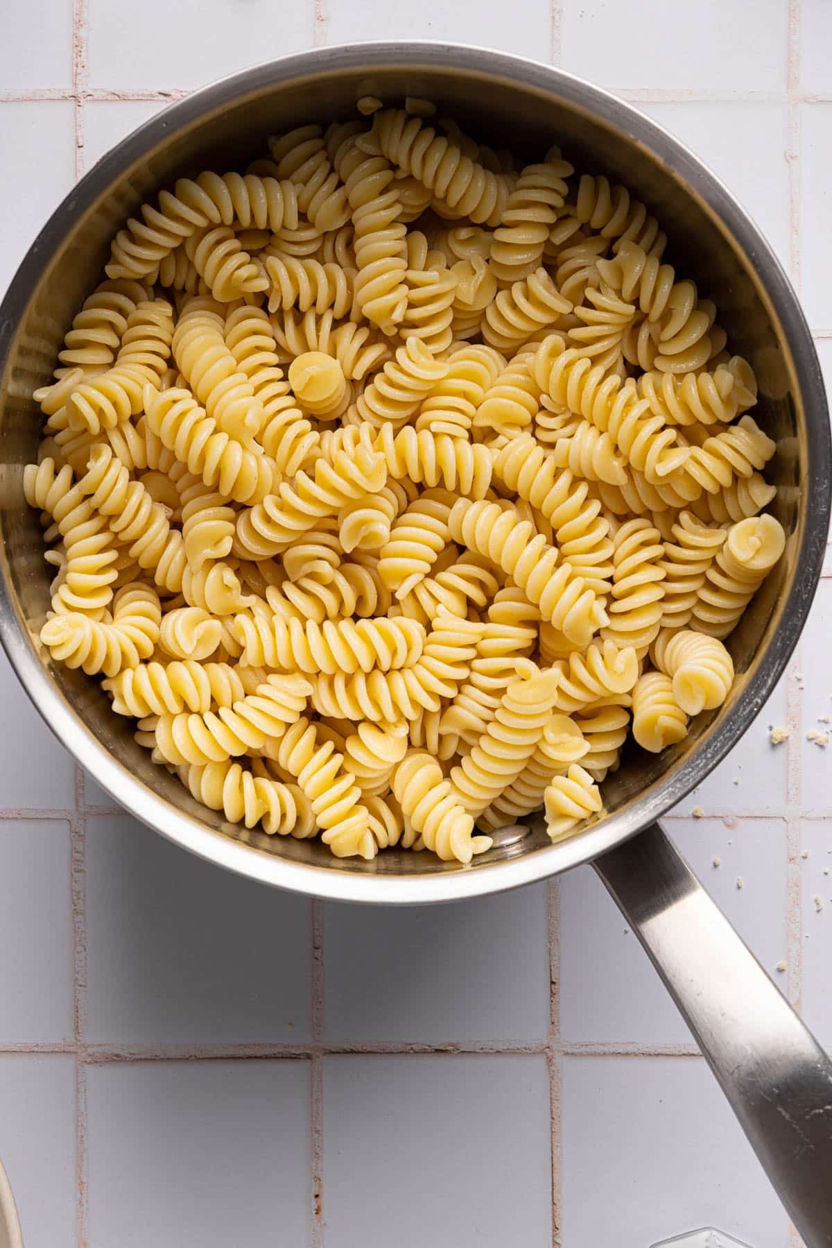 Cooked pasta in a large saucepan after cooking and drained.
