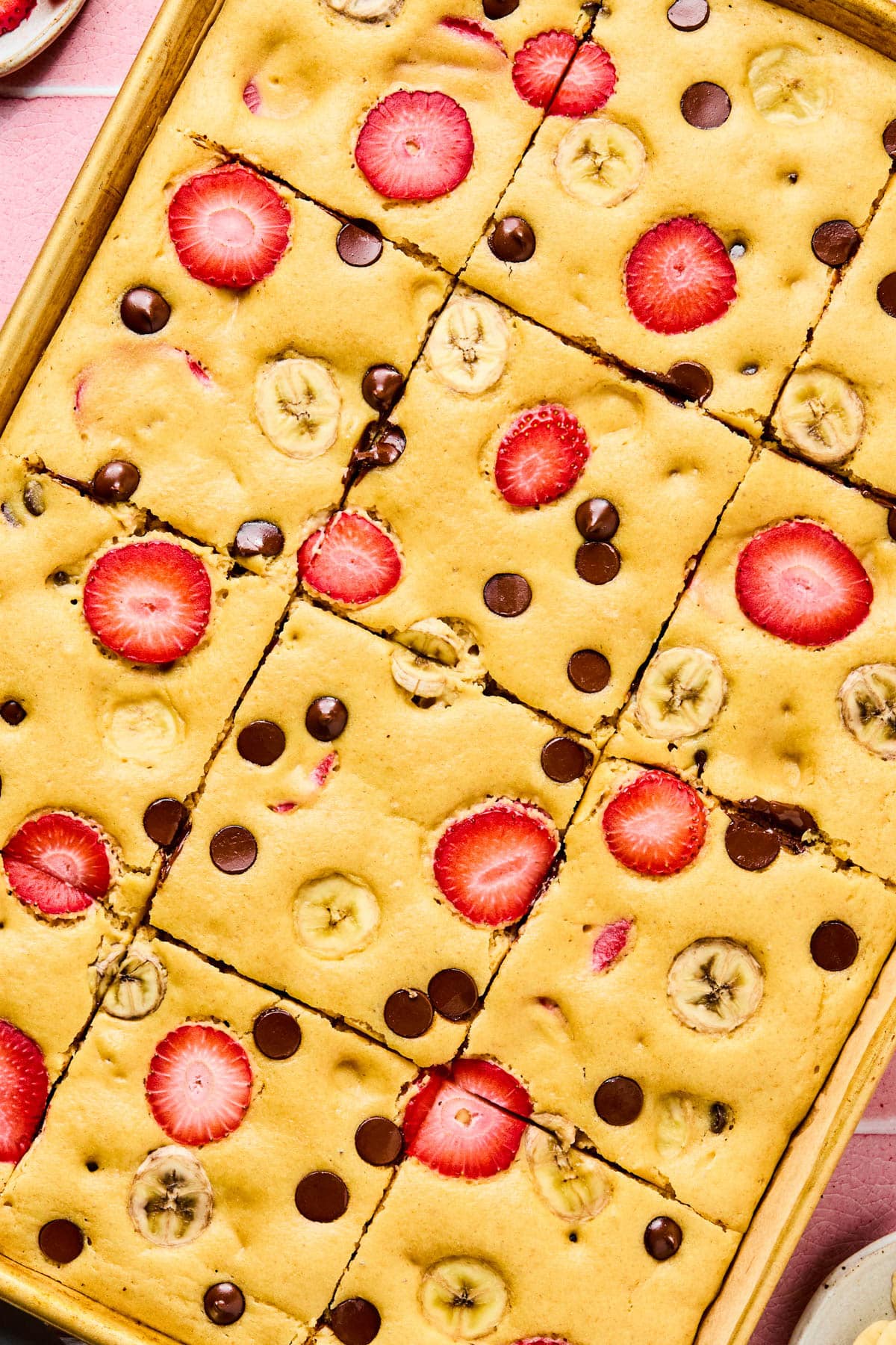 The baked sheet pan pancakes cut into 12 slices in the sheet pan.