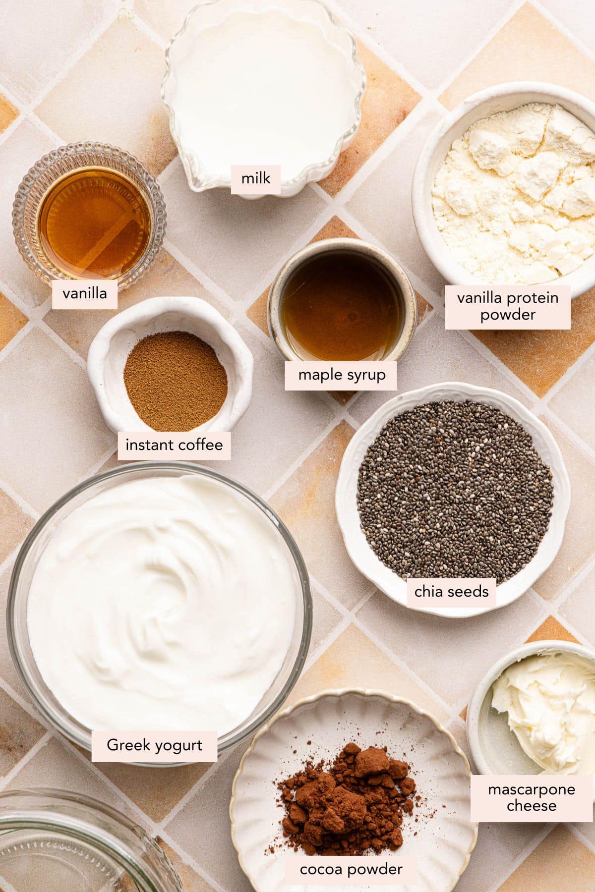 All of the ingredients for tiramisu chia pudding in bowls on a countertop.