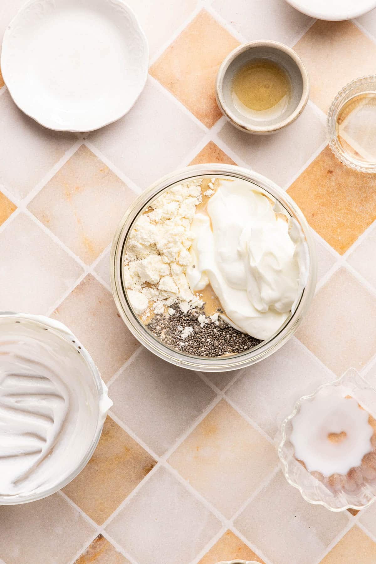 The chia seeds, protein powder, vanilla, maple syrup, and greek yogurt in the jar with the milk and coffee mixture.