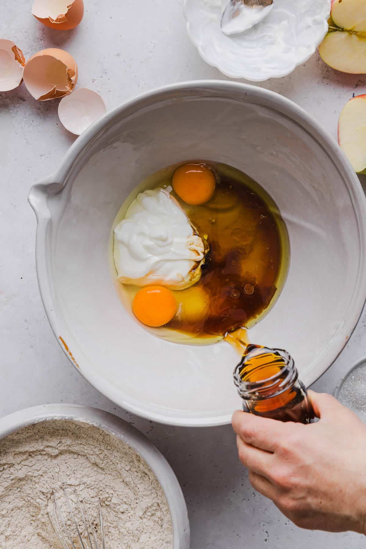 The greek yogurt, honey, oil, eggs, and vanilla in a bowl before mixing.