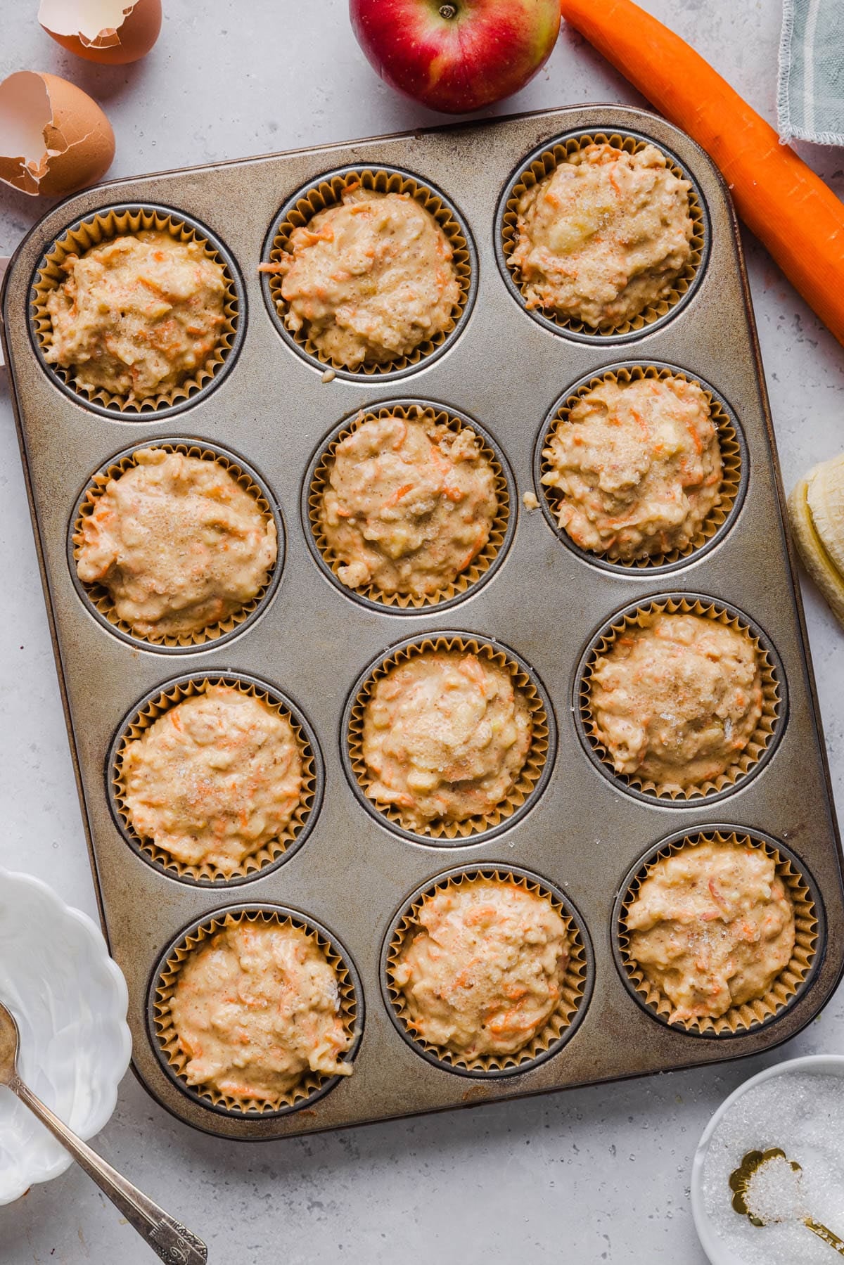 The muffin batter in the muffin cups before baking.
