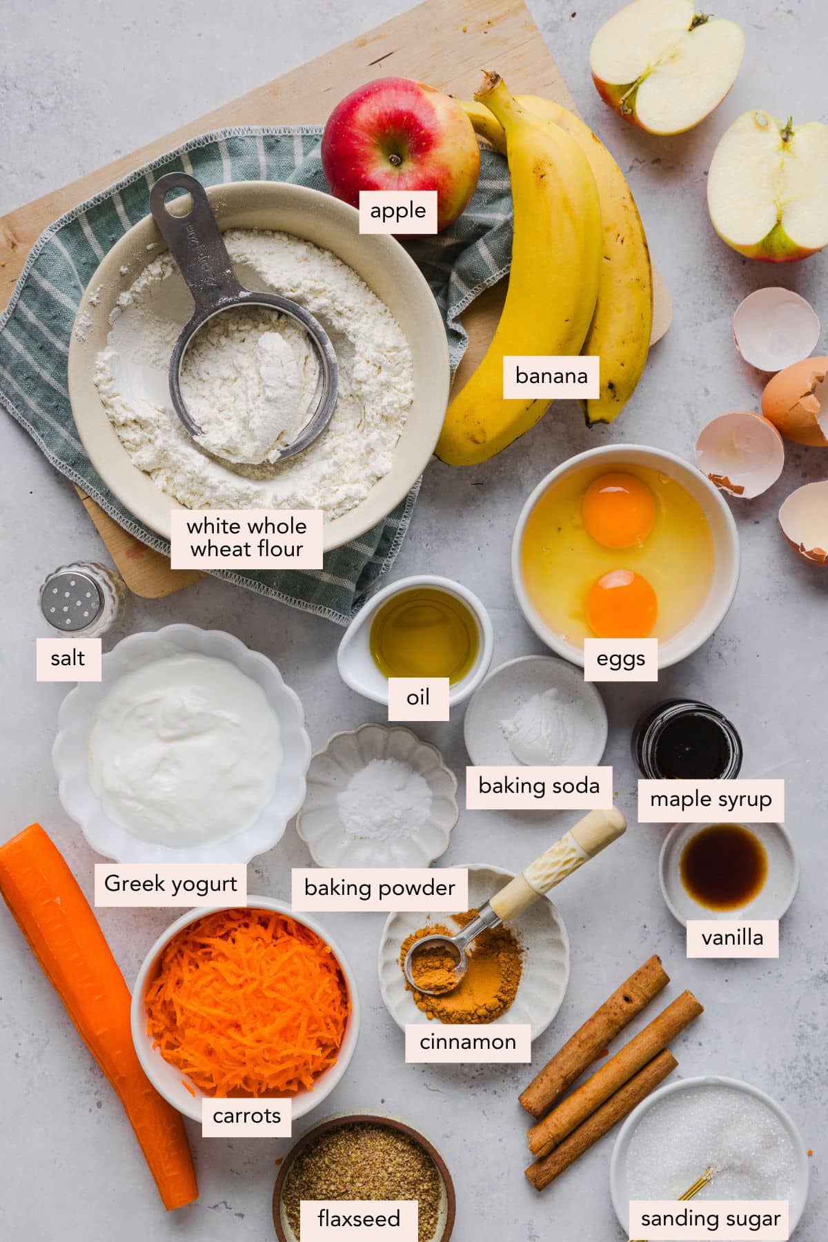 All of the ingredients for abc muffins in bowls on a countertop.