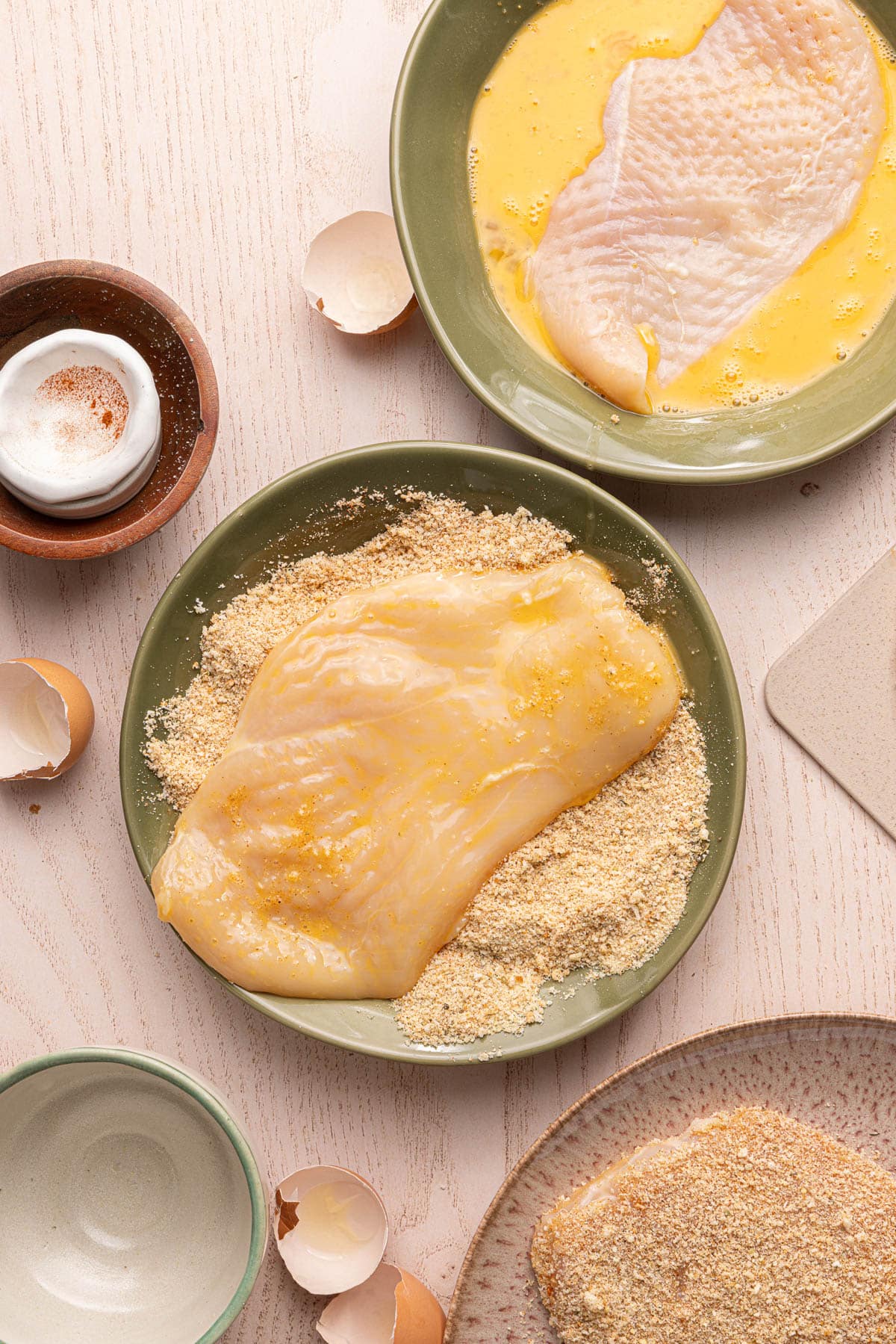 A chicken cutlet dredged in egg and then tossed in the breadcrumb mixture.