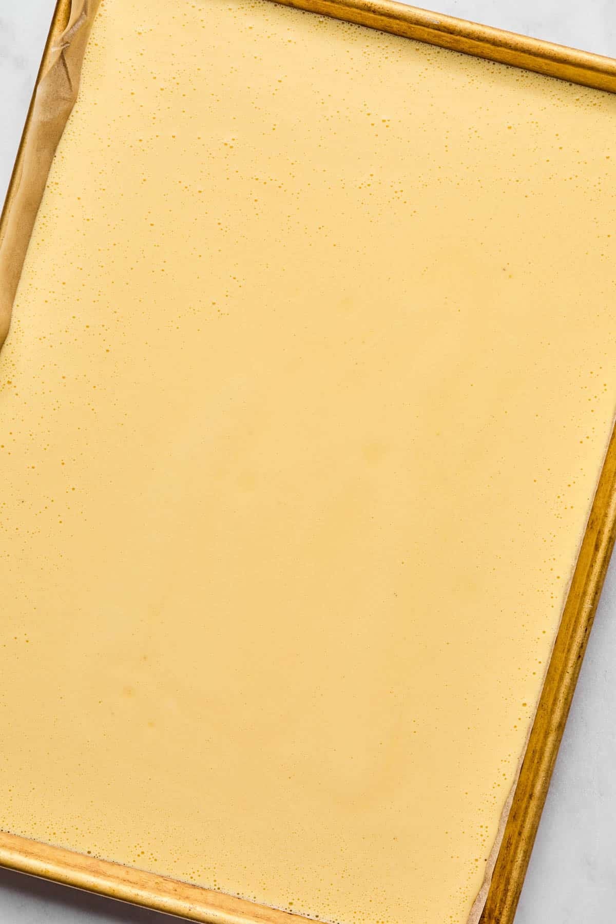 The blended egg mixture spread in the prepared pan before baking.