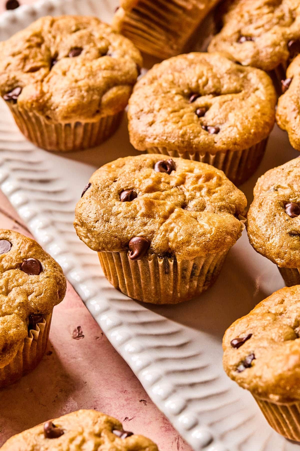 Cottage cheese chocolate chip muffins on a white serving platter.