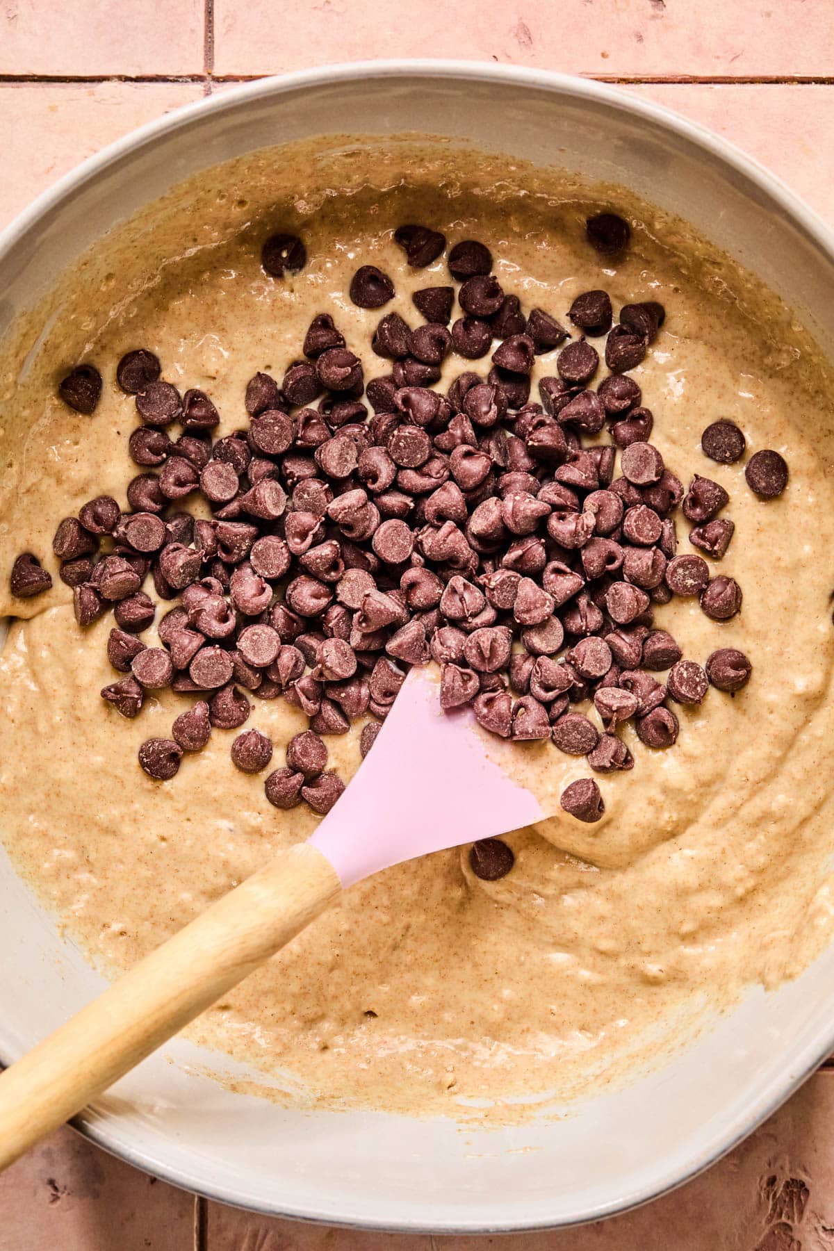 The chocolate chips on top of the batter before mixing in.