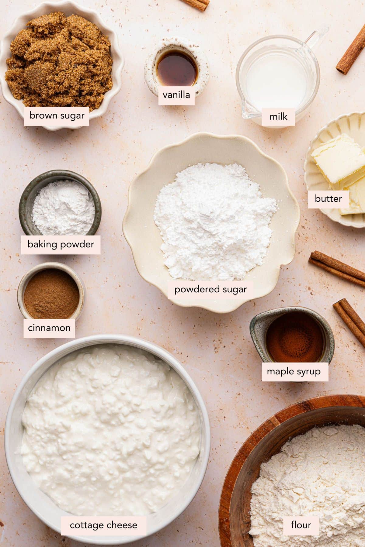 All of the ingredients for cottage cheese cinnamon rolls in bowls on a countertop.