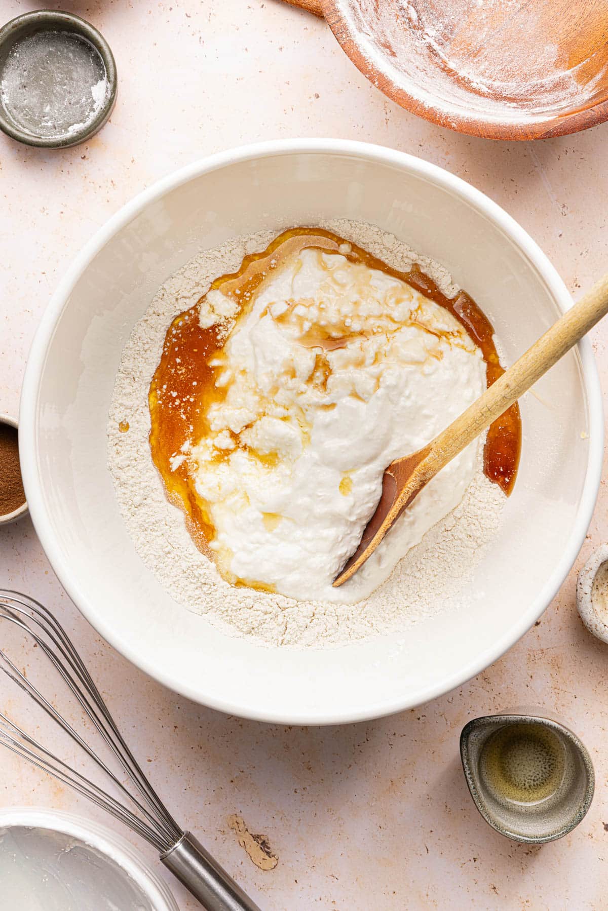 The cottage cheese, vanilla, and maple syrup in the bowl with the flour baking powder mixture before stirring everything together.