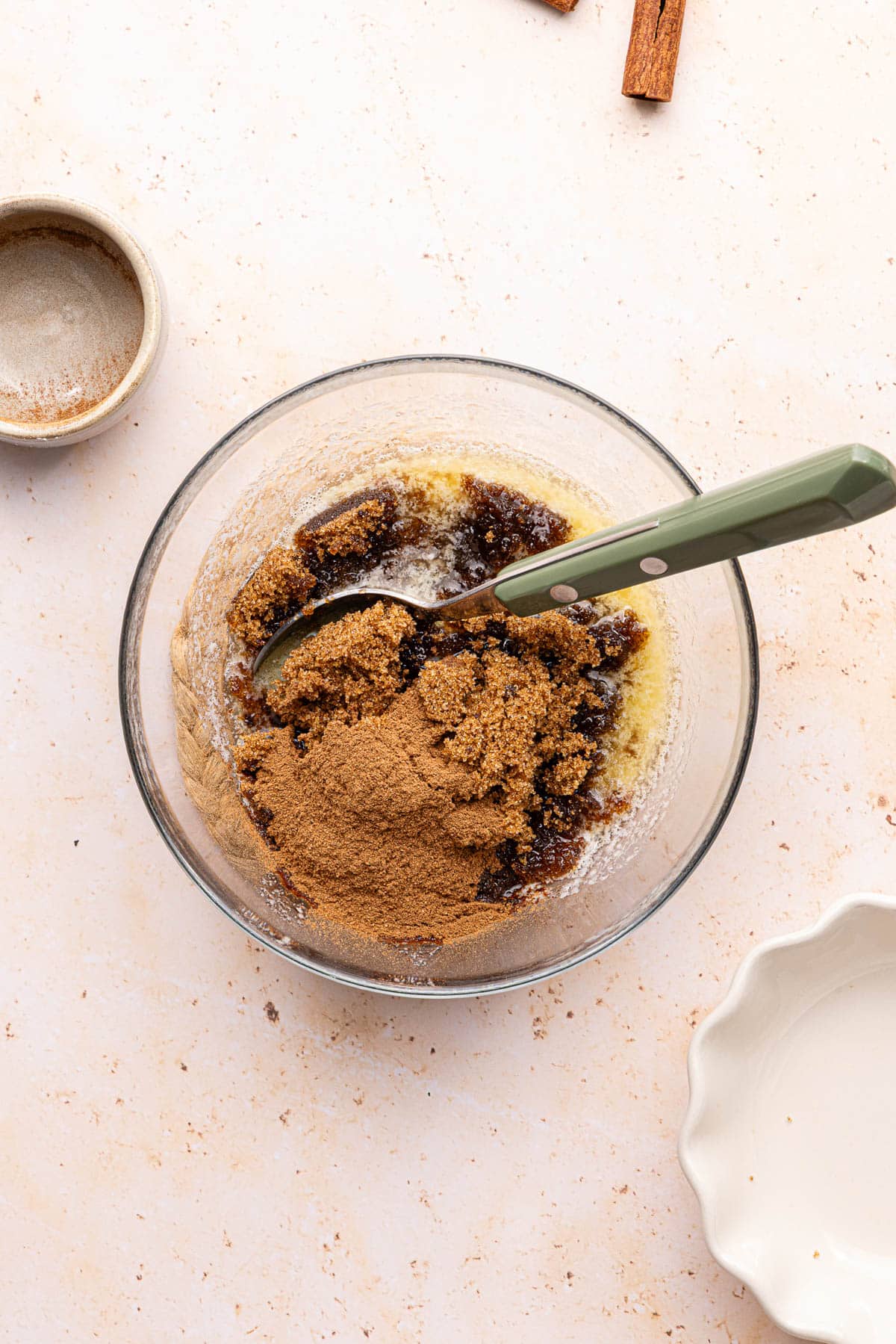 The butter, brown sugar, and cinnamon in a glass bowl before mixing.