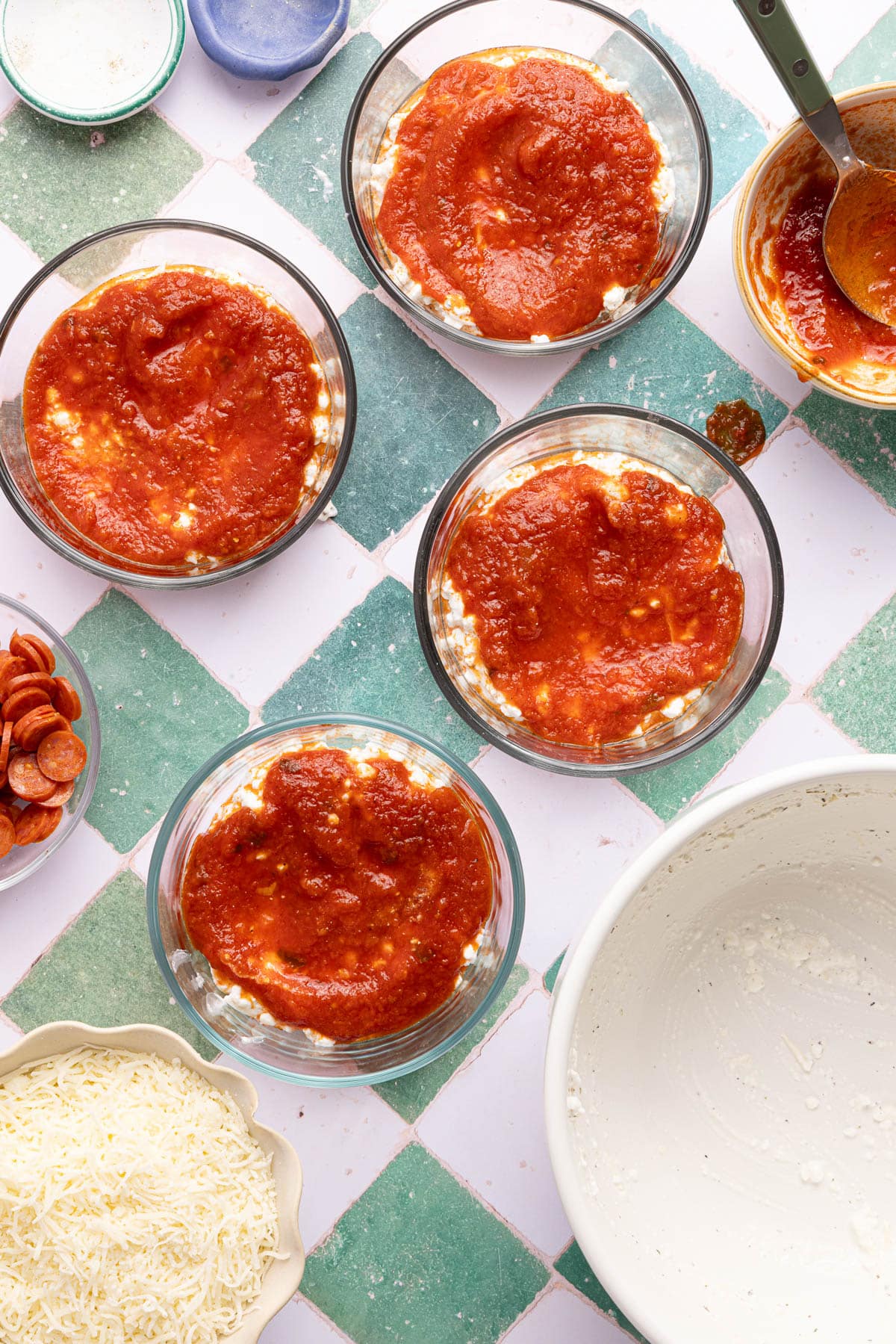 The sauce over the cottage cheese mixture in 4 bowls.