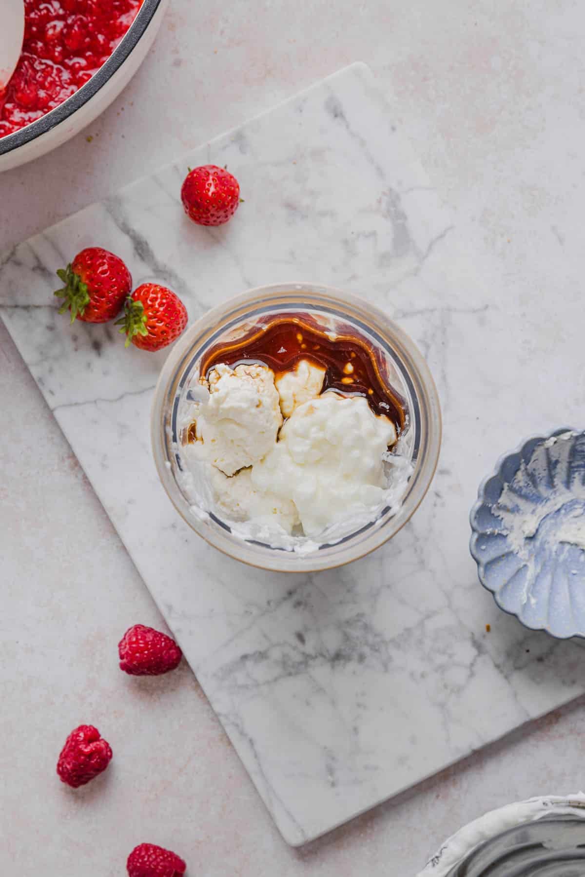 Yogurt, cottage cheese, cream cheese, maple syrup, and vanilla in a blender before blending.