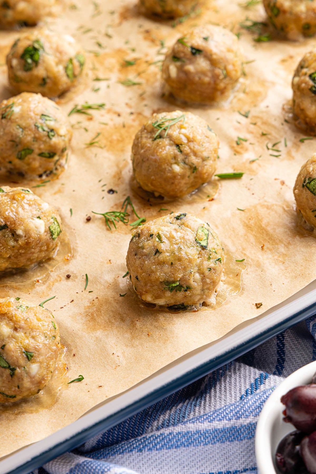 The baked meatballs on a baking sheet after baking.