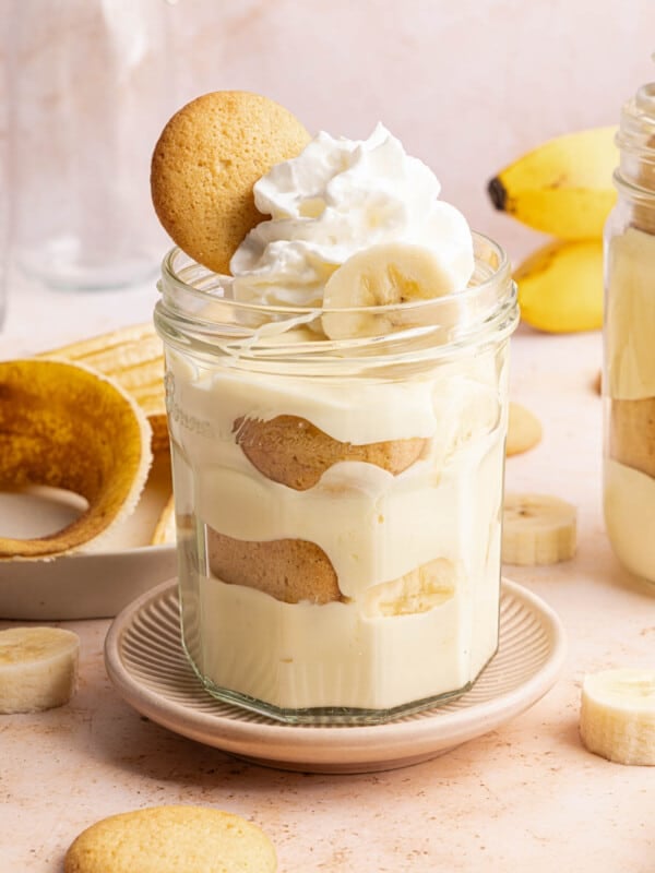 A jar filled with cottage cheese banana pudding on a countertop for serving.