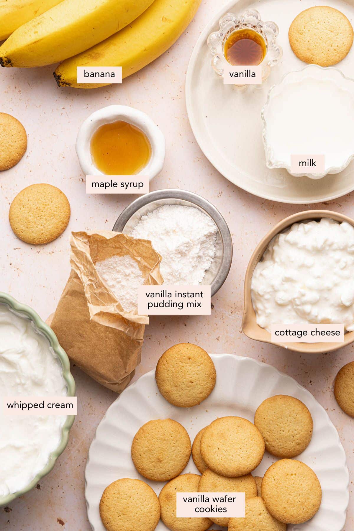All of the ingredients for cottage cheese banana pudding in bowls on a countertop.