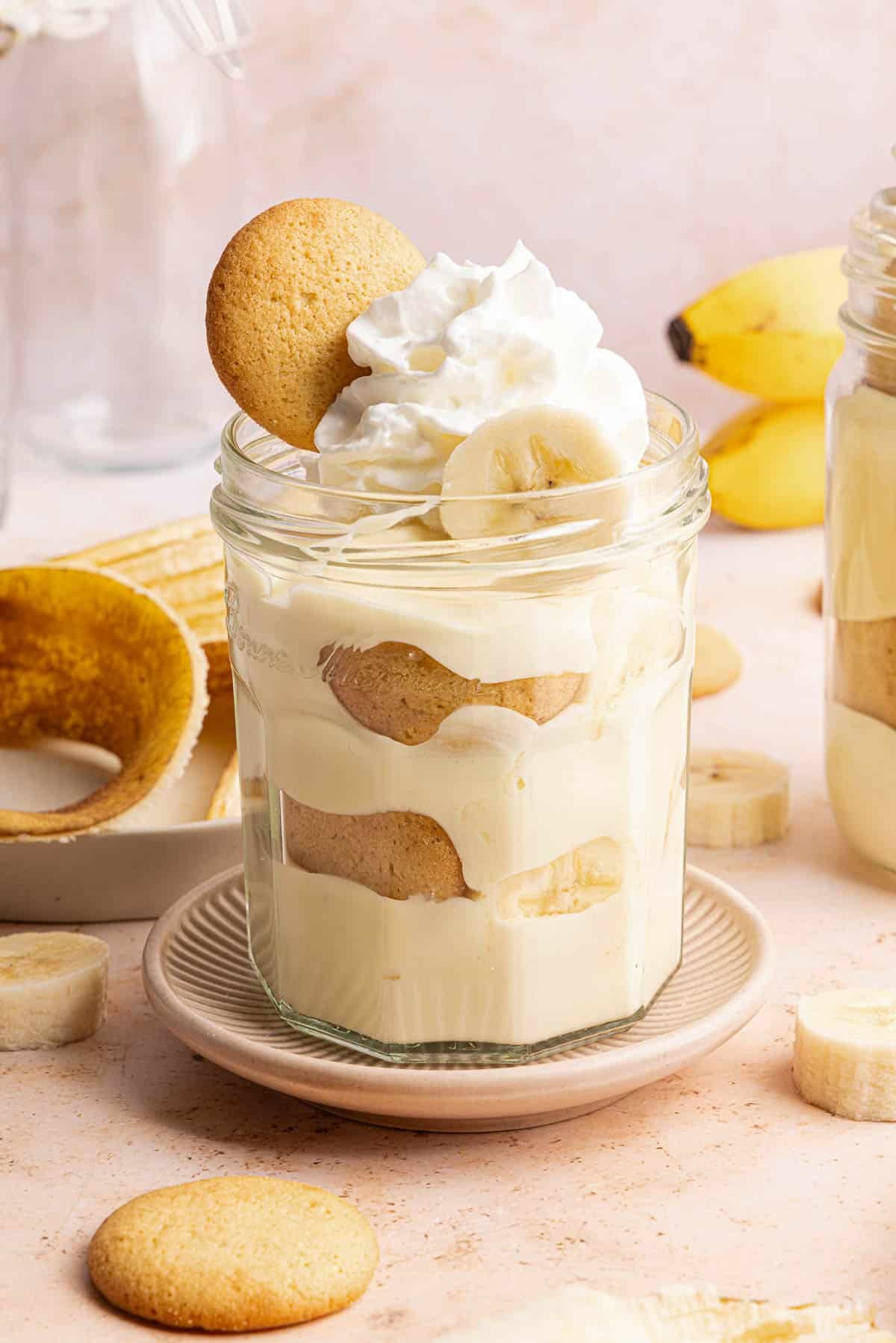 A jar filled with cottage cheese banana pudding on a countertop for serving.
