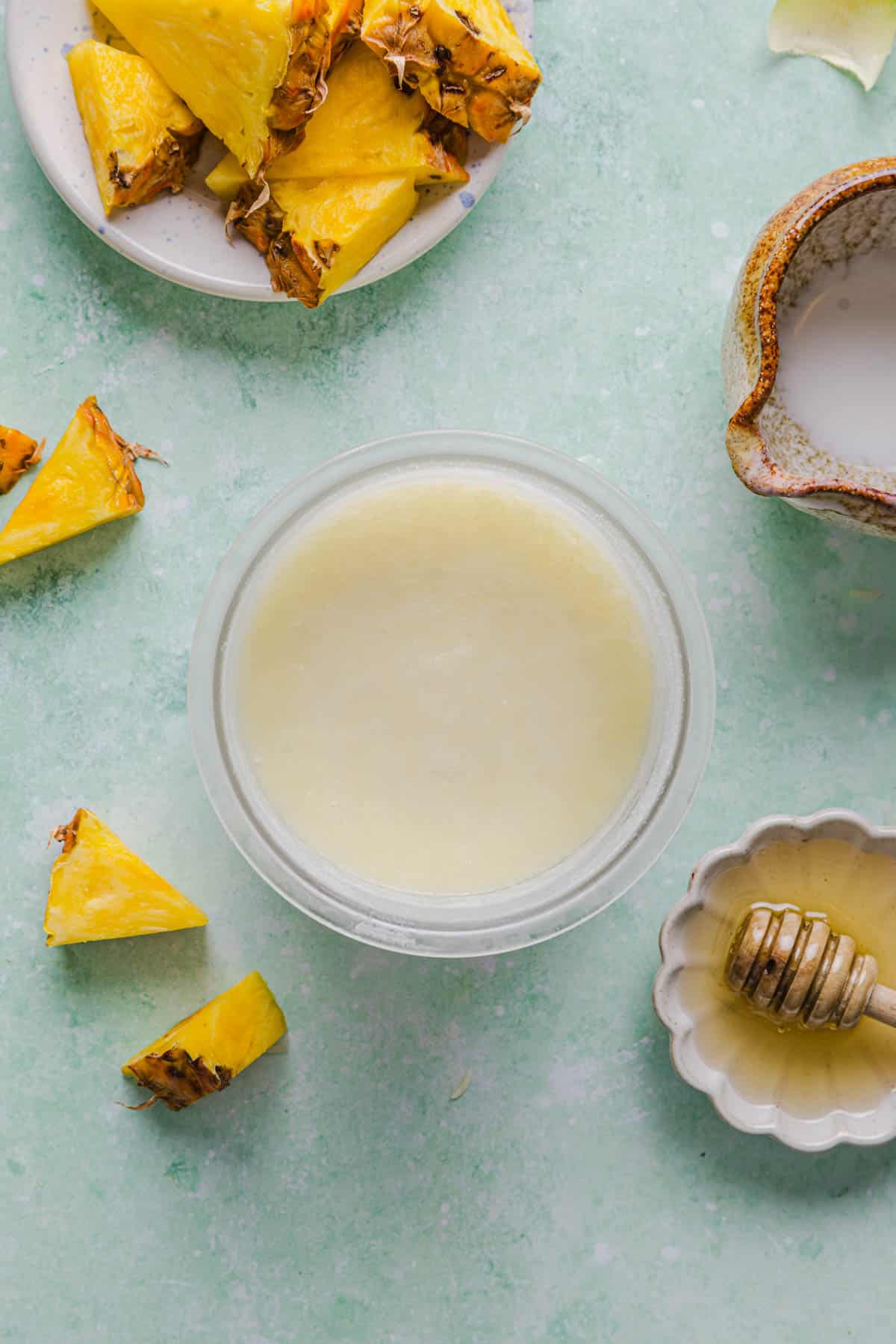 The pineapple dole whip mixture after chilling in the Ninja Creami container before spinning.