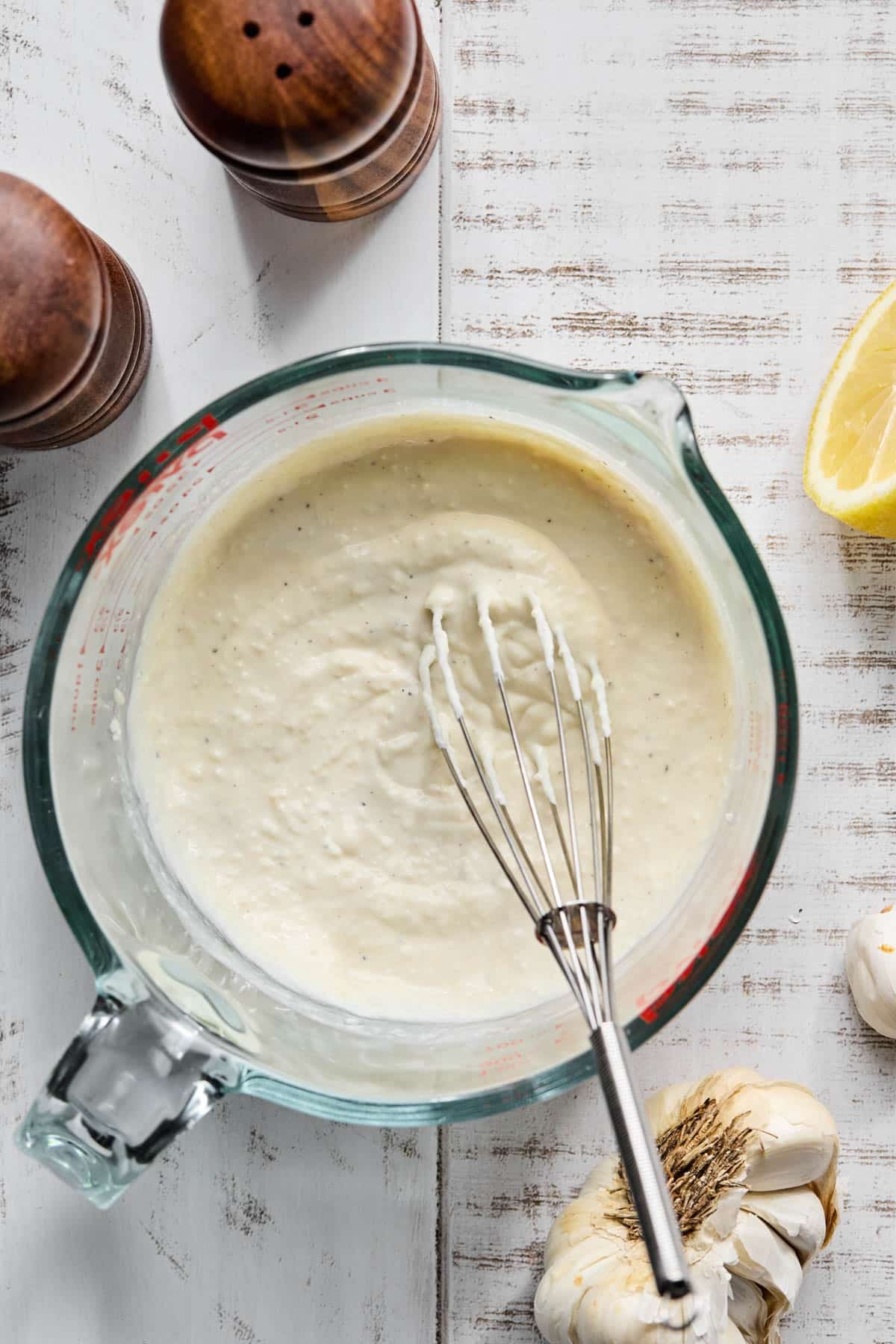 The greek yogurt caesar dressing whisked together in a large bowl.