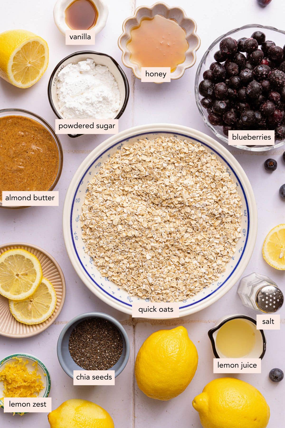 All of the ingredients for lemon blueberry bars in bowls on a countertop.