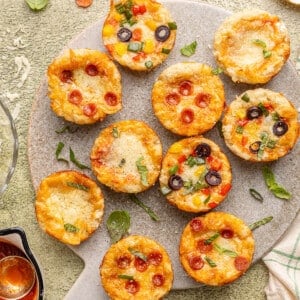 Pizza cups on a serving board after baking.