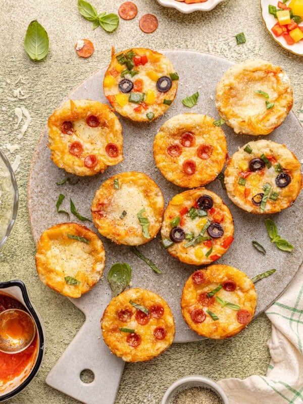Pizza cups on a serving board after baking.