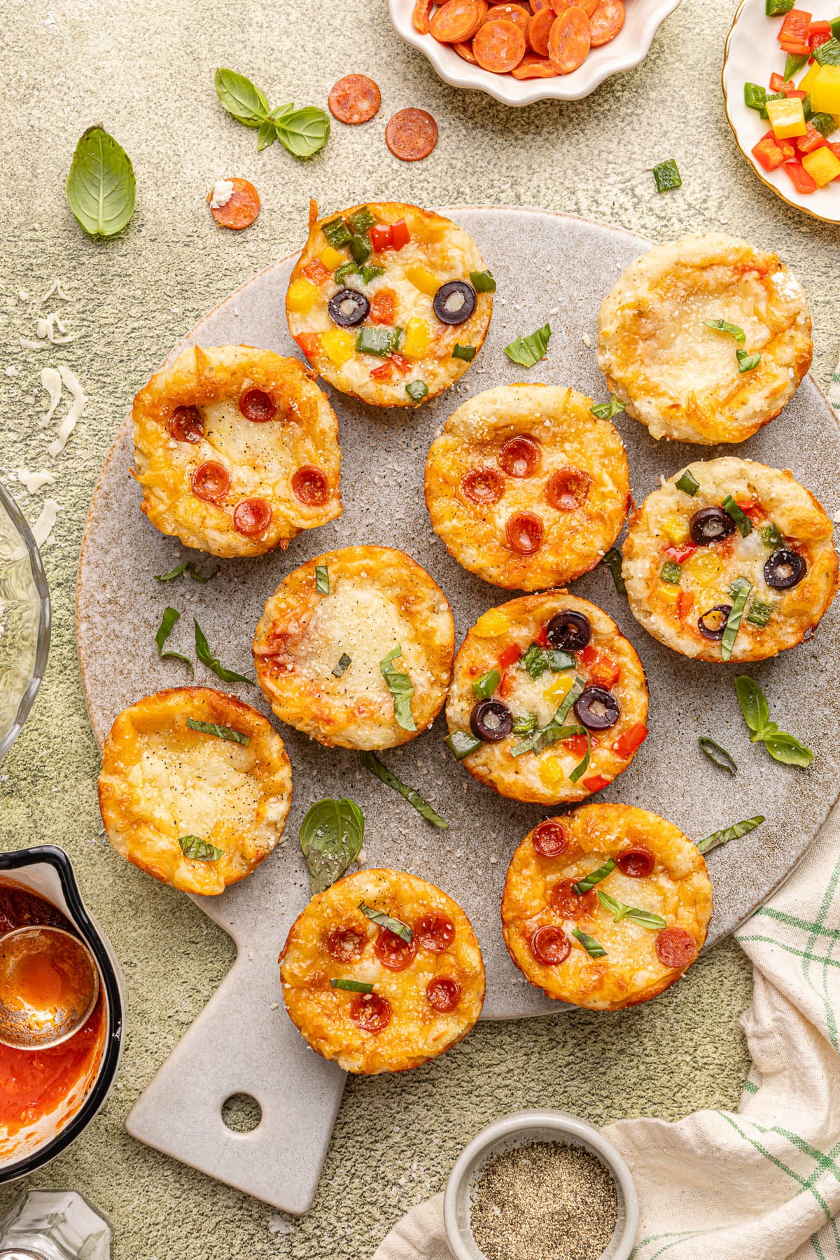 Pizza cups on a serving board after baking.