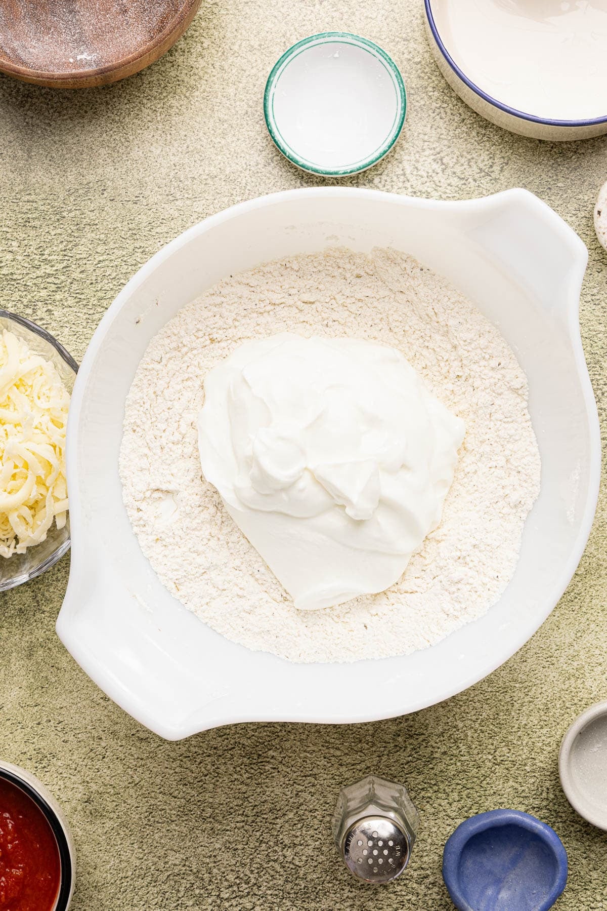 The greek yogurt in the bowl with the dry ingredients.