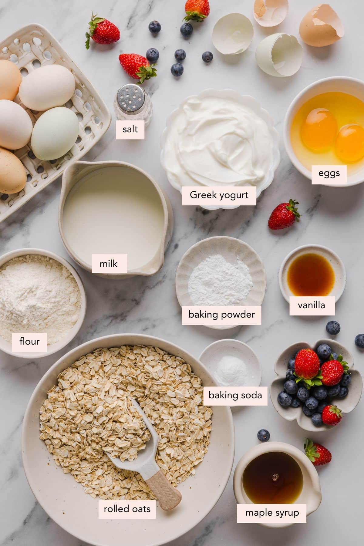 All of the ingredients for protein waffles in bowls on a countertop.