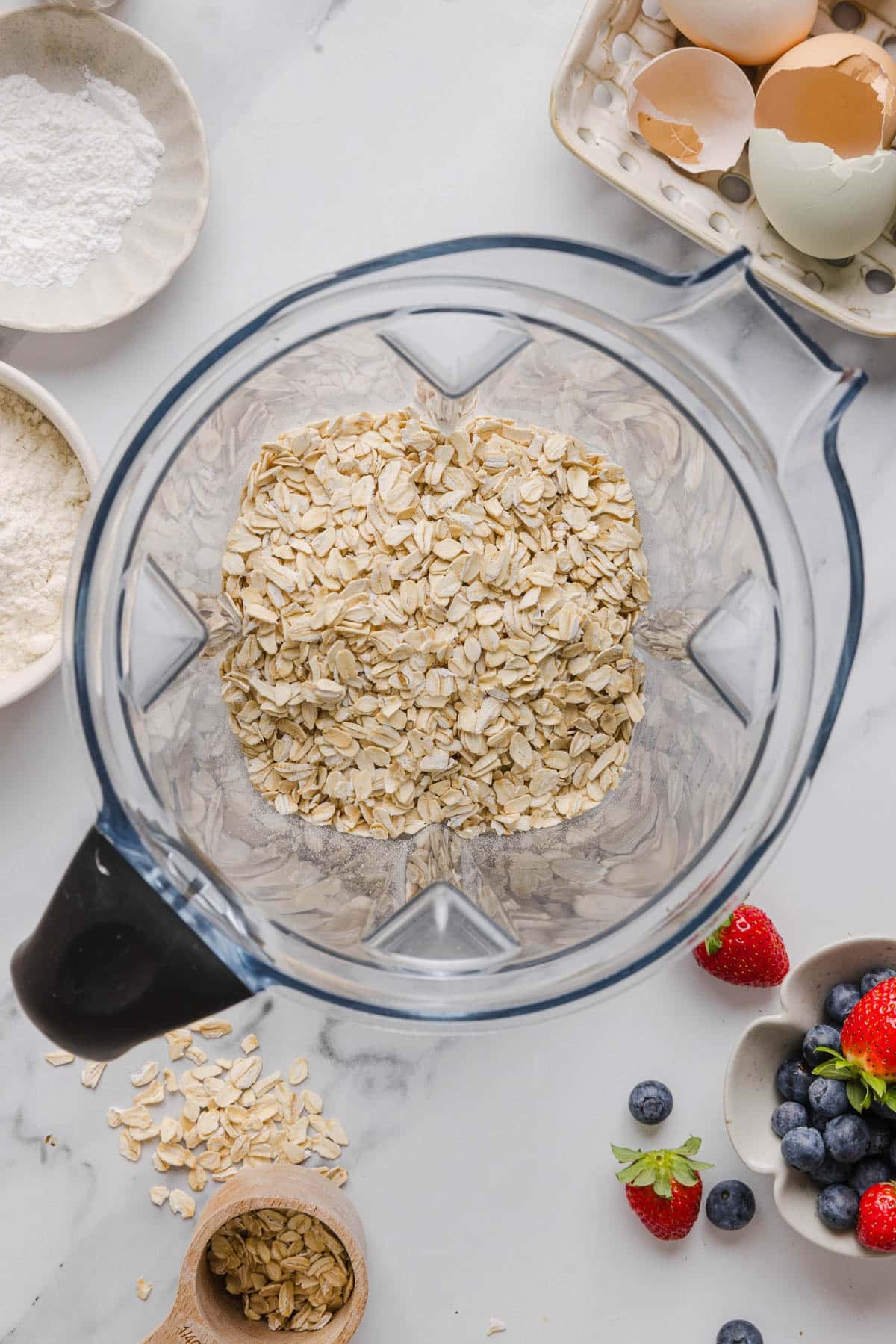The oats in the blender before blending into flour.