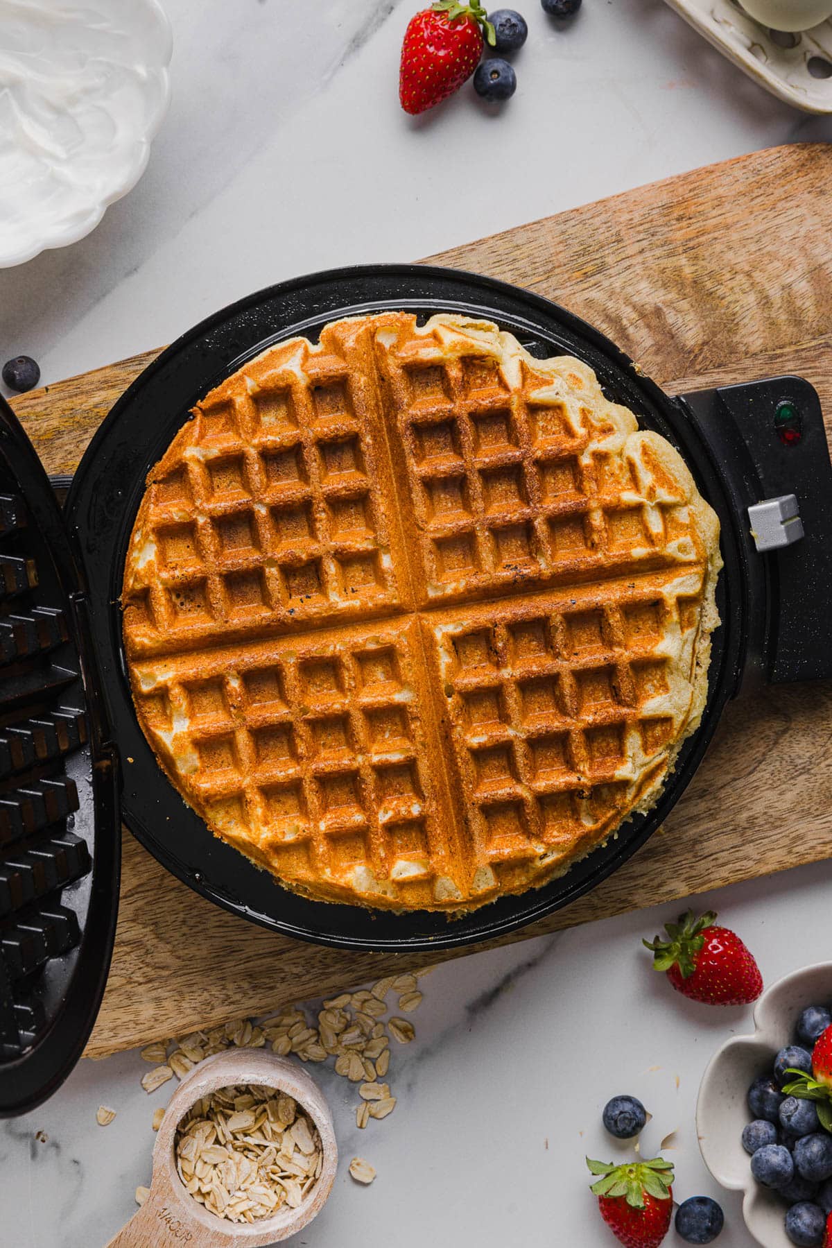 The cooked waffle in the waffle iron after cooking.