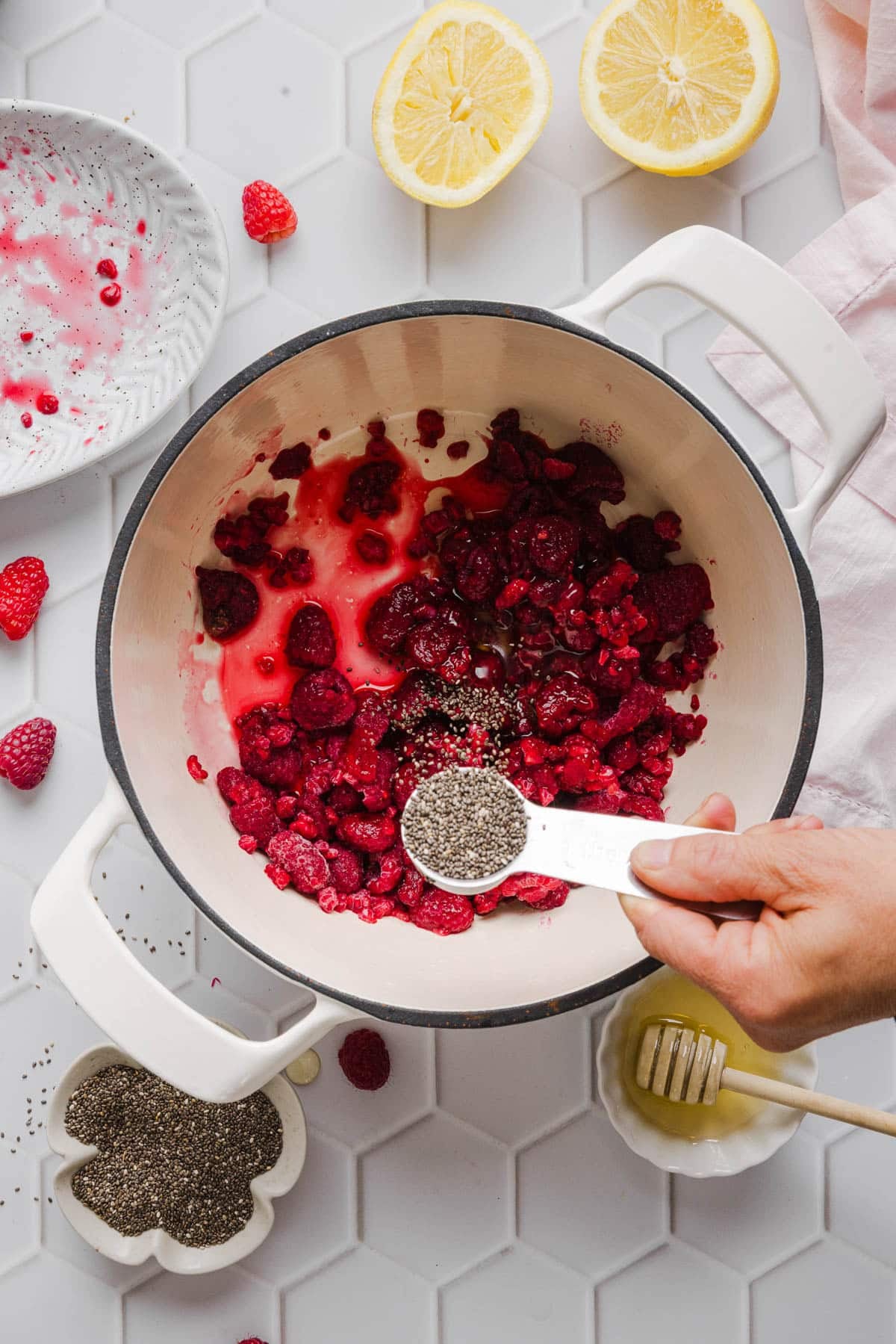 All of the ingredients for the jam in a saucepan before breaking down the berries.