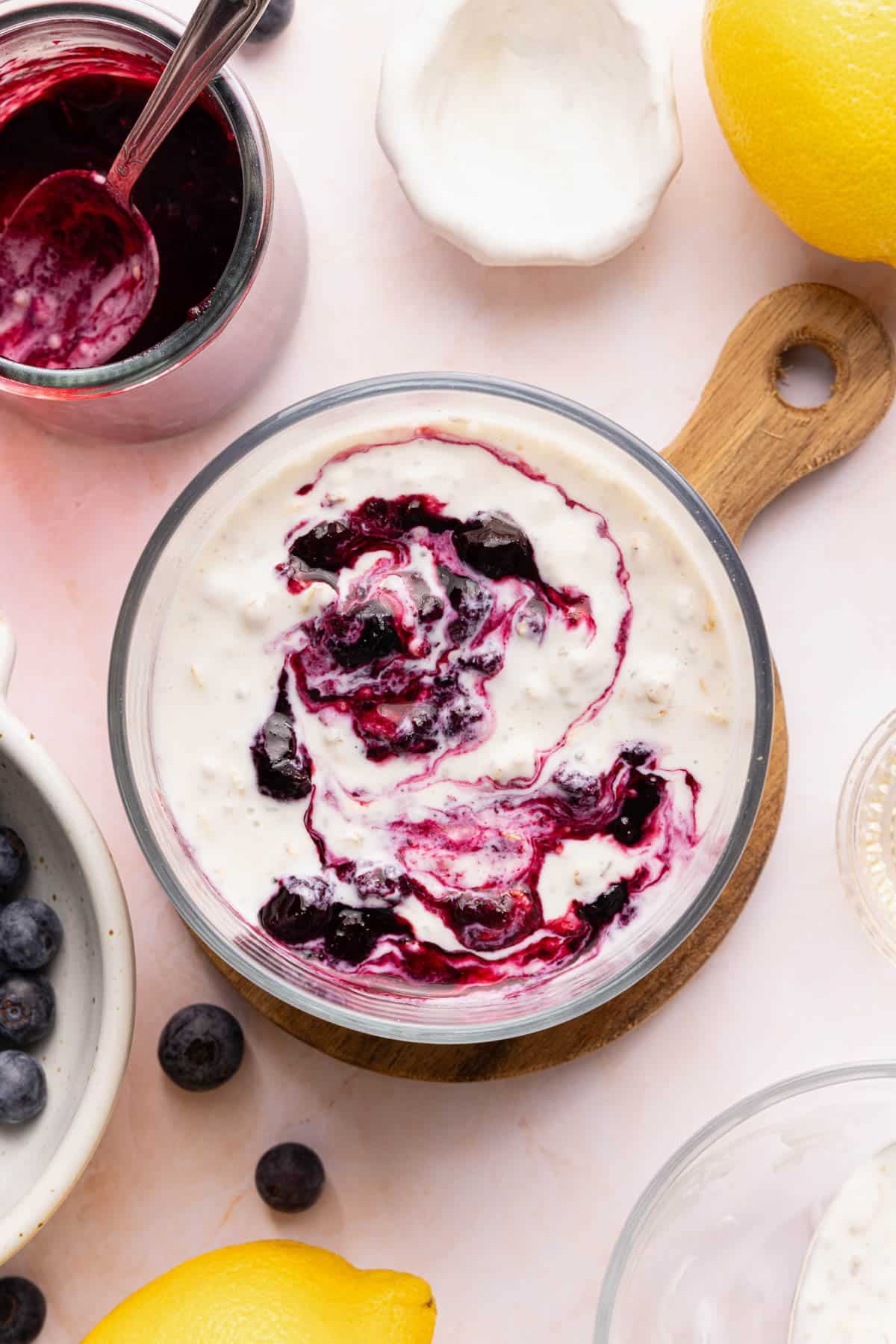 The lemon blueberry overnight oats in a jar with fresh blueberries on top.