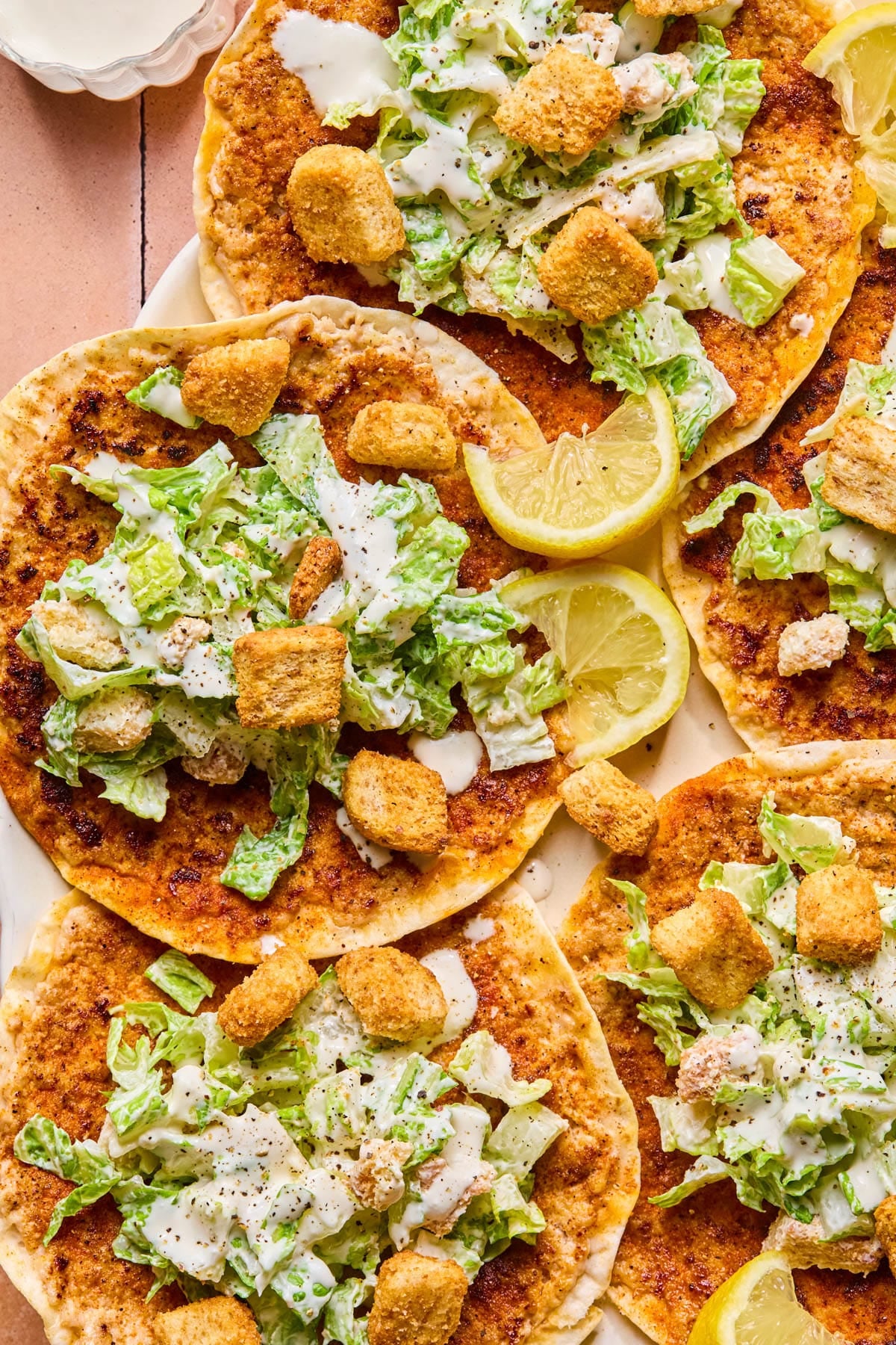 The fully assembled chicken caesar smashed tacos on a serving platter.