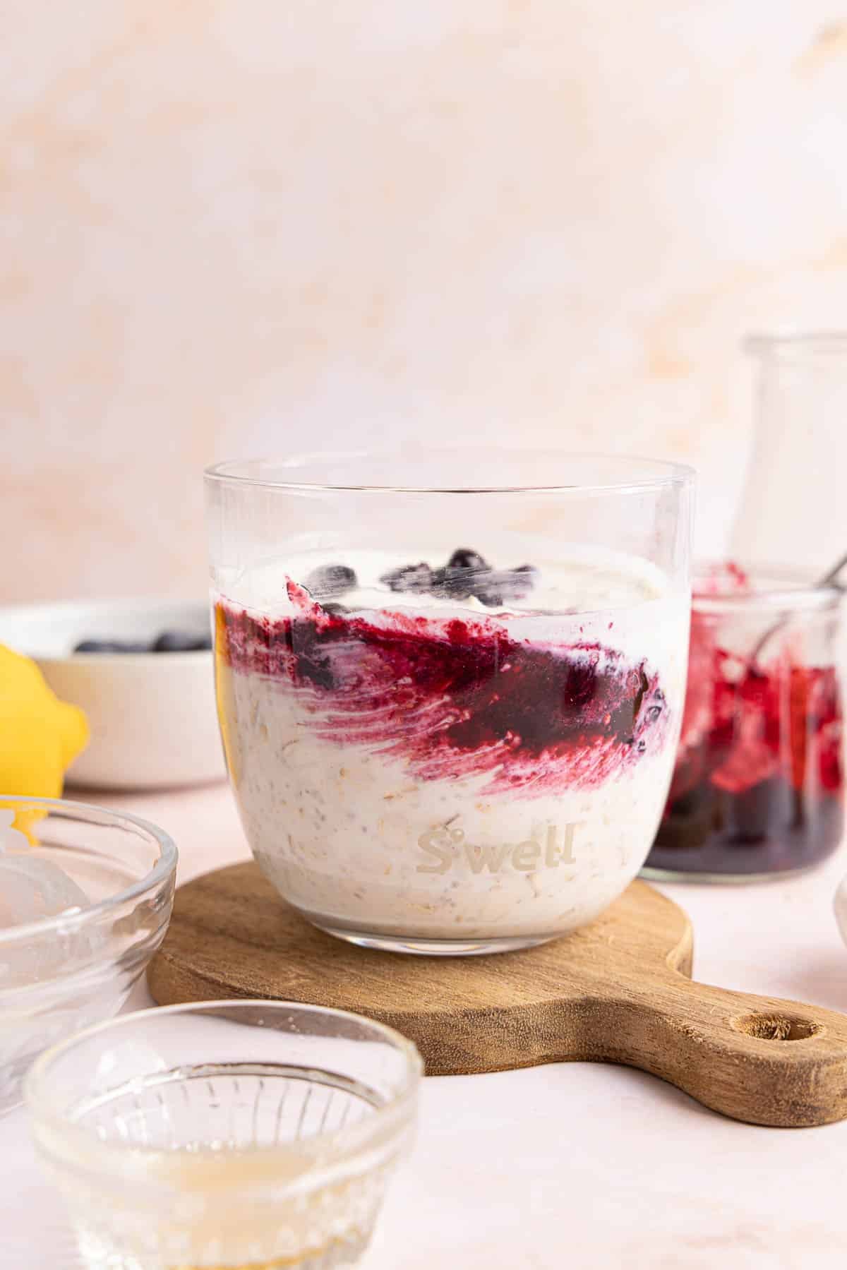 The blueberry jam swirled into the mixture in the glass jar.