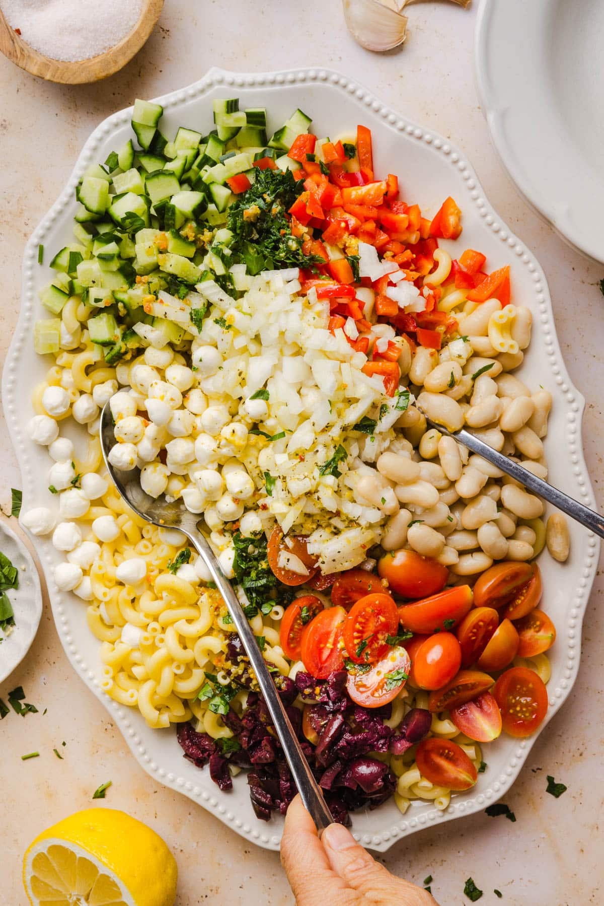 The dressing poured over the salad ingredients just before mixing everything together.