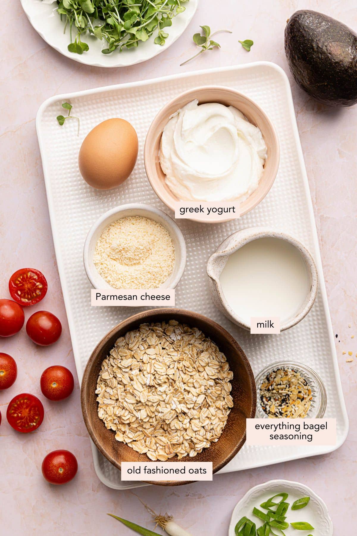 All of the ingredients for savory overnight oats in bowls on a countertop.