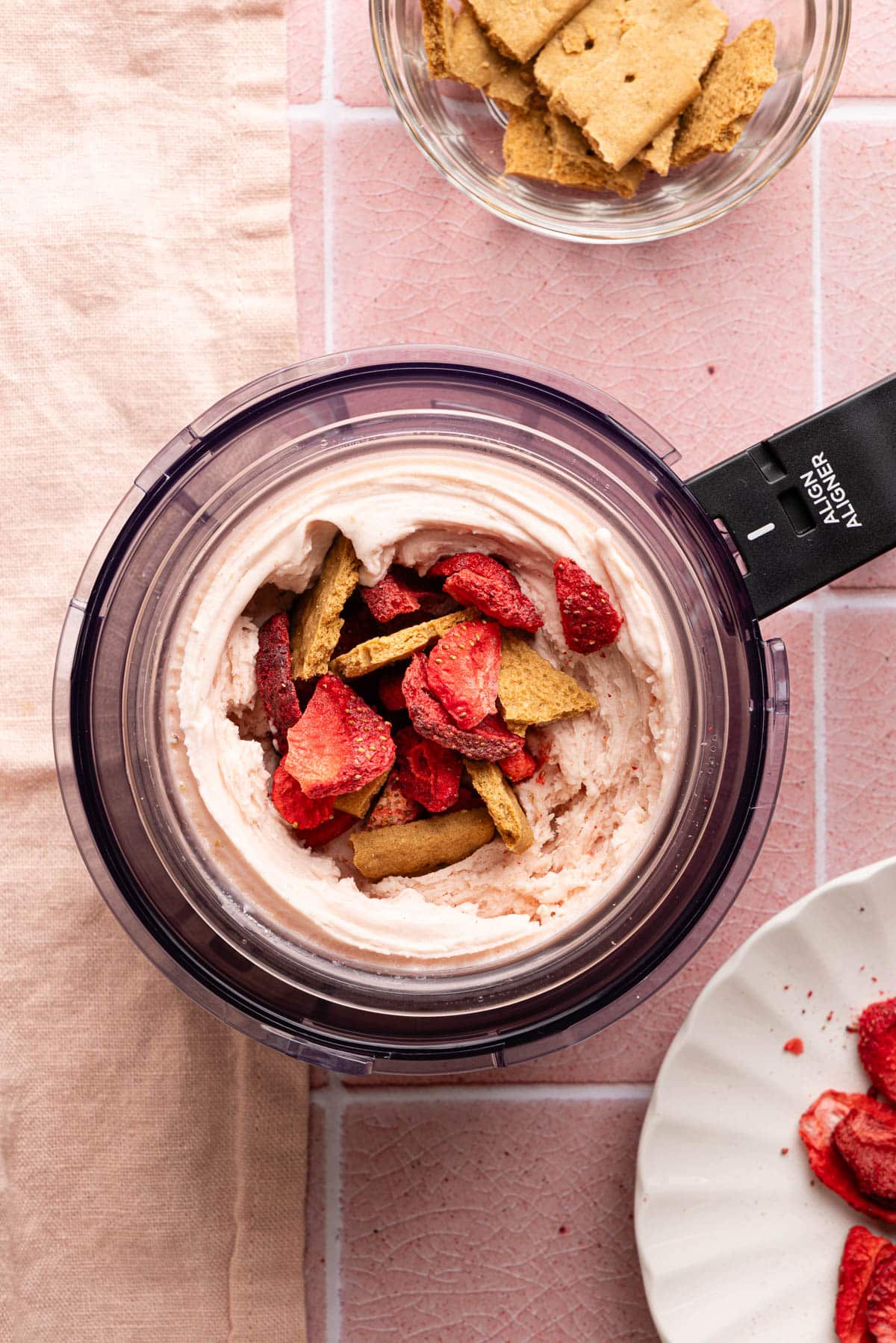 The freeze dried strawberries and golden graham crackers in the hole in the middle of the ice cream before mixing in.