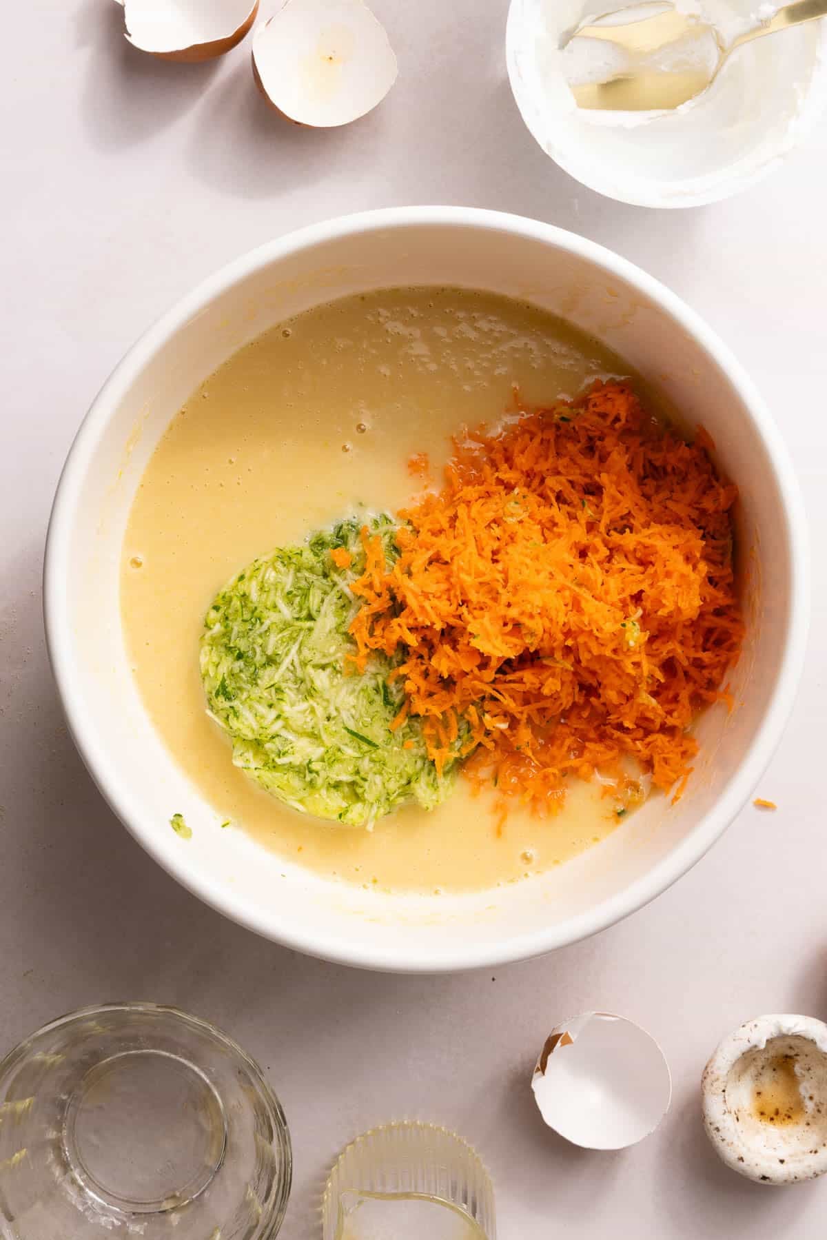 The shredded carrots and zucchini in the bowl with the wet ingredients.