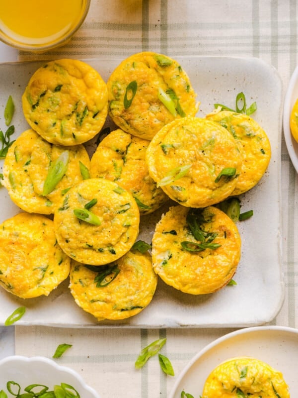 Zucchini Egg Muffins with cottage cheese on a white serving platter on a countertop.