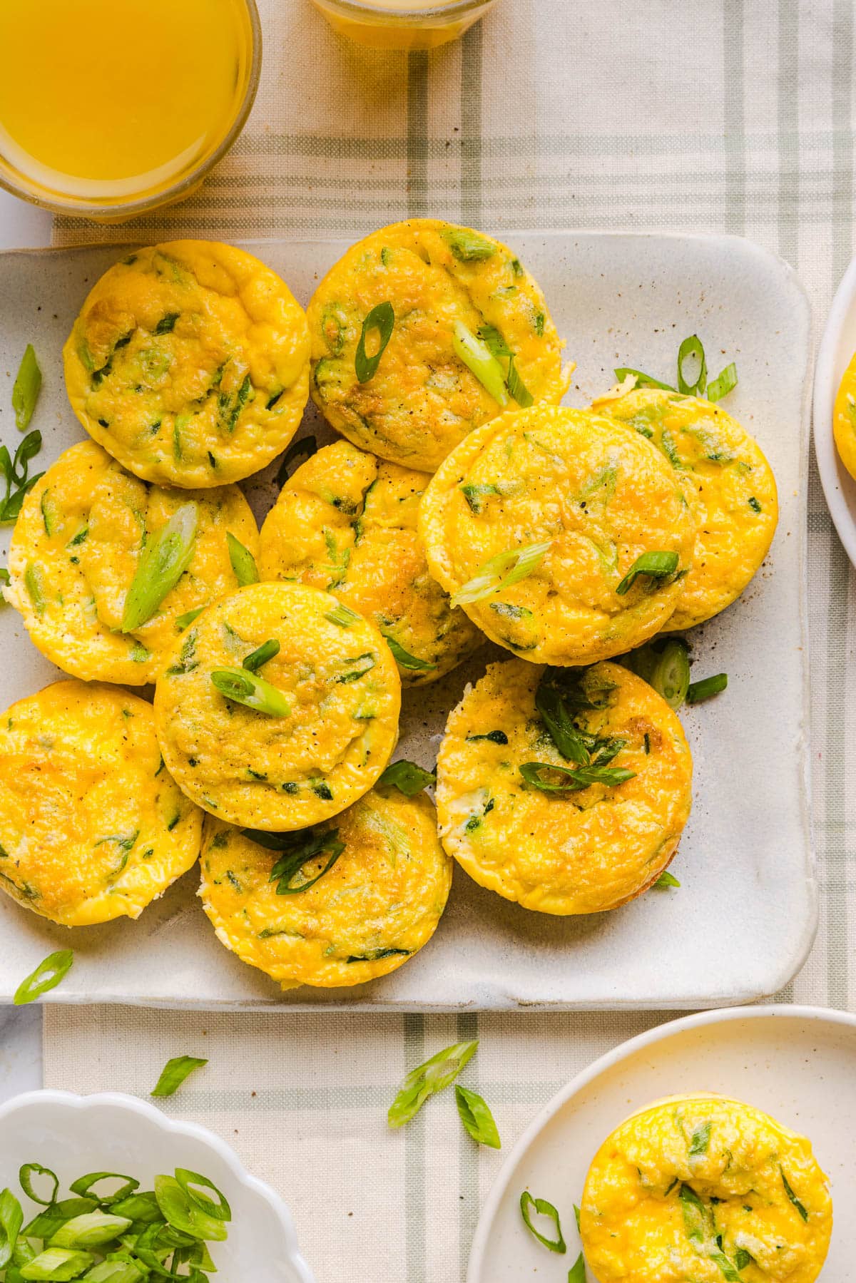 Zucchini Egg Muffins with cottage cheese on a white serving platter on a countertop.