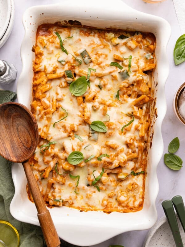 A spoon rests on the edge of the cottage cheese pasta bake.