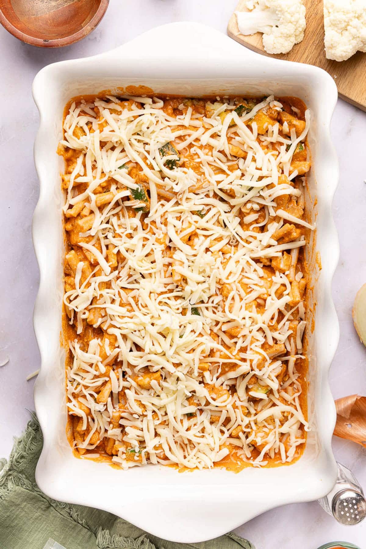 The cheese sprinkled on top of the mixed pasta mixture before baking.