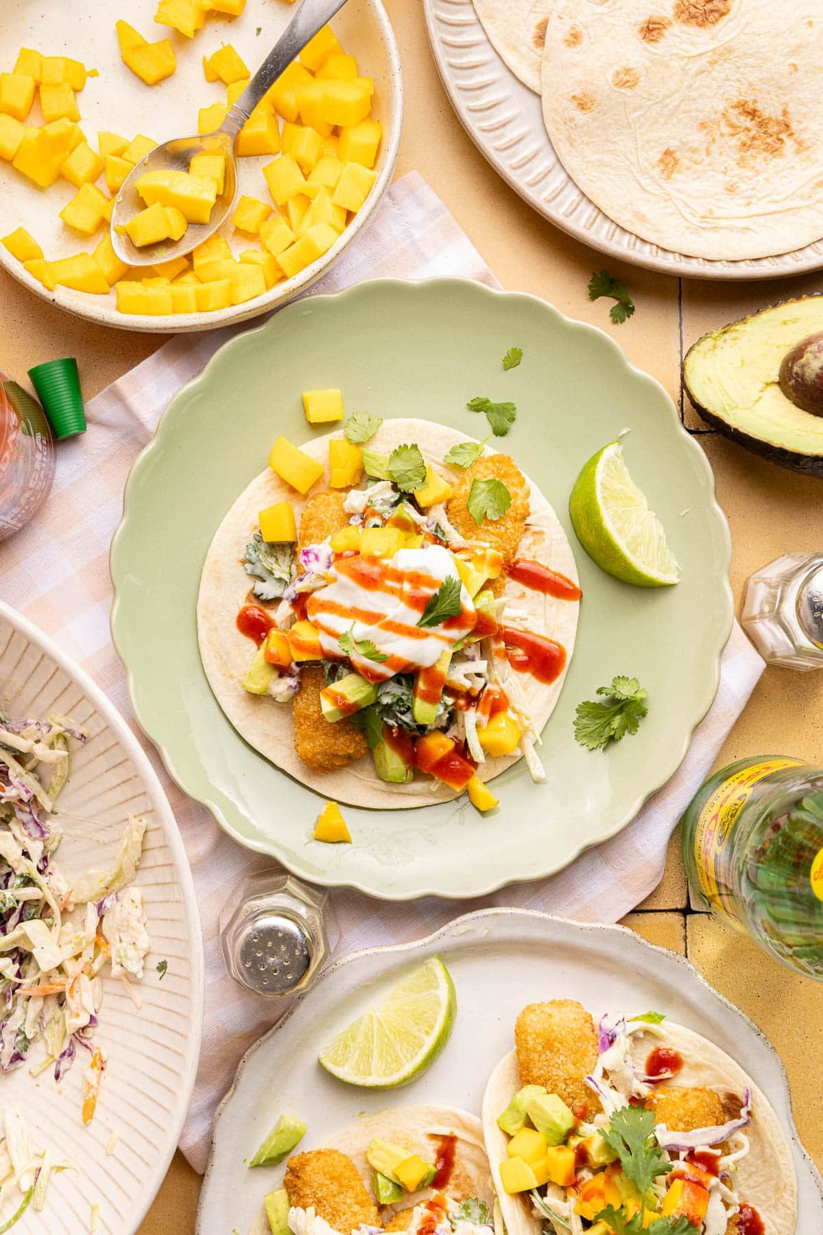 An assembled taco on a green plate.