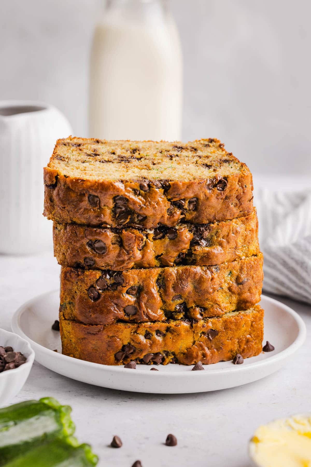 A stack of four slices of protein zucchini bread on a plate.