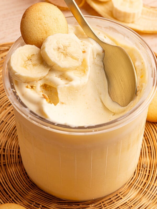 A spoon rests in a container of high-protein banana pudding ice cream made in the Ninja Creami.