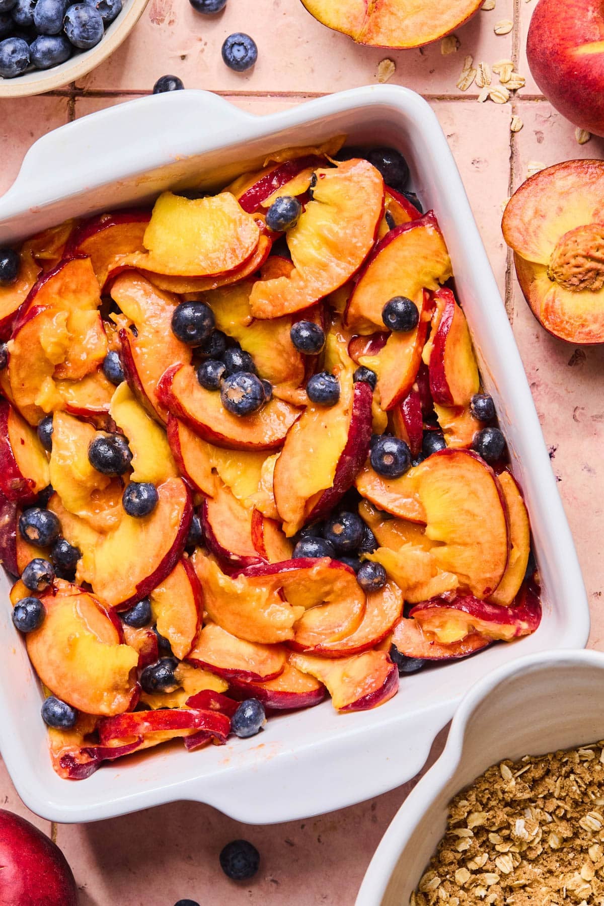 The fruit mixture in a 9x9" white baking dish.
