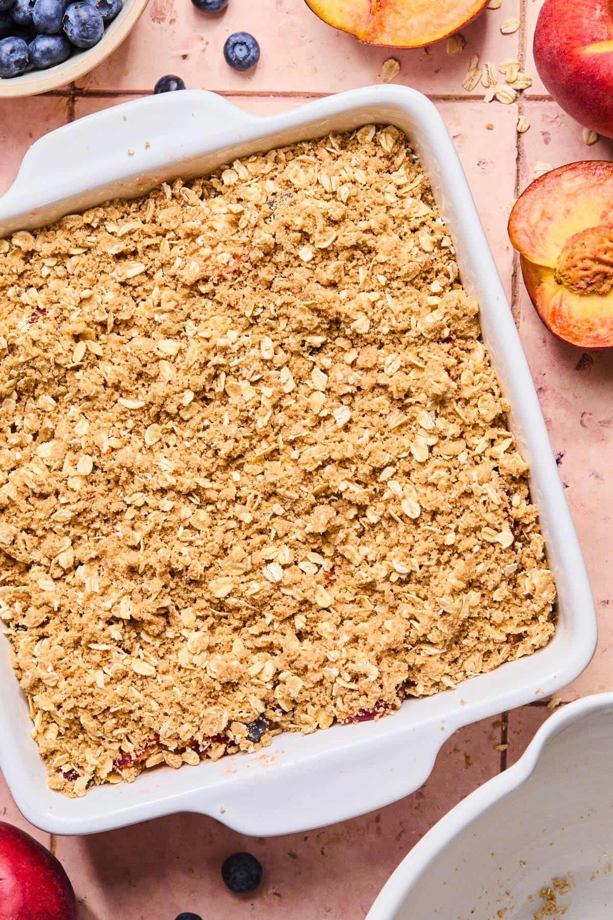 The crumble topping on the fruit mixture before baking.