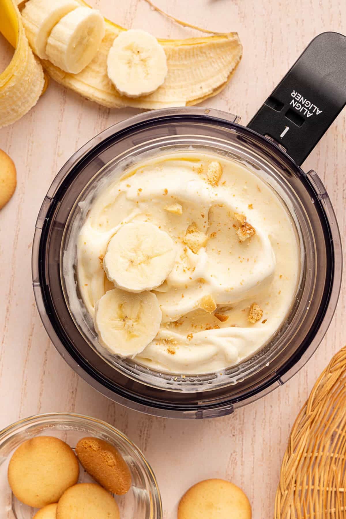 The finished banana pudding ice cream in the ninja creami container on a countertop.